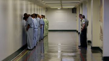 In this Oct. 27, 2011 photo, deputies have inmates line up along a wall, as seen during a tour of the Men's Central Jail, run by the Los Angeles County Sheriff's Department, in downtown Los Angeles. Sheriffs Department investigations into jailhouse inmate abuse were often handled internally and never submitted to Los Angeles County prosecutors, it was learned Monday, Dec. 5, 2011. Sheriff Lee Baca says it was a mistake not to submit cases in which deputies were suspended or fired. (AP Photo/Reed Saxon)