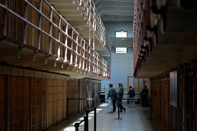 FILE - People tour the main cell house on Alcatraz Island in San Francisco, Monday, March 15, 2021, as the historic island prison was reopened to visitors after being closed since Dec. 2020, because of the coronavirus threat. U.S. Interior Secretary Deb Haaland on Saturday, Nov. 20, said progress has been made by Indigenous people during a visit to Alcatraz Island, which became a symbol of the struggles of Native People for self-determination following its takeover in the 1960s, but more remains to be done. (AP Photo/Eric Risberg, File)