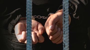 The,Man,In,The,Handcuffs,Is,Behind,Bar,In,The