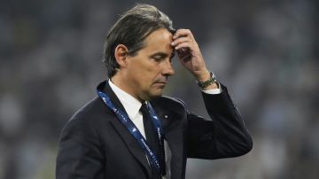 Inter Milan's head coach Simone Inzaghi walks away with his second place medal at the end of the Champions League final soccer match between Paris Saint-Germain and Inter Milan at the Allianz Arena in Munich, Germany, Saturday, May 31, 2025. (AP Photo/Luca Bruno)