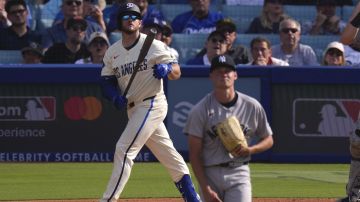 Los Angeles Dodgers' Max Muncy, left heads to first for a two-run home run as New York Yankees starting pitcher Will Warren watches during the second inning of a baseball game Saturday, May 31, 2025, in Los Angeles. (AP Photo/Mark J. Terrill)