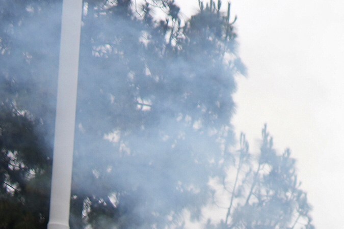 A woman waves a Mexican flag amidst tear gas from law enforcement during a protest in Paramount, Calif., Saturday, June 7, 2025, after federal immigration authorities conducted operations. (AP Photo/Eric Thayer)
