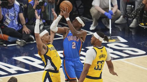 Oklahoma City Thunder guard Shai Gilgeous-Alexander (2) shoots over Indiana Pacers guard Andrew Nembhard, left, and Indiana Pacers center Myles Turner (33) during the first half of Game 4 of the NBA Finals basketball series, Friday, June 13, 2025, in Indianapolis. (AP Photo/Michael Conroy)
