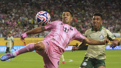 Inter Miami's Luis Suarez kicks the ball away from Palmeiras' Marcos Rocha during the Club World Cup Group A soccer match between Inter Miami and Palmeiras in Miami Gardens, Fla., Monday, June 23, 2025. (AP Photo/Lynne Sladky)