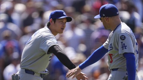 Los Angeles Dodgers' Shohei Ohtani, left, congratulates first baseman Freddie Freeman, right, after their team defeated the Colorado Rockies in a baseball game Thursday, June 26, 2025, in Denver. (AP Photo/David Zalubowski)