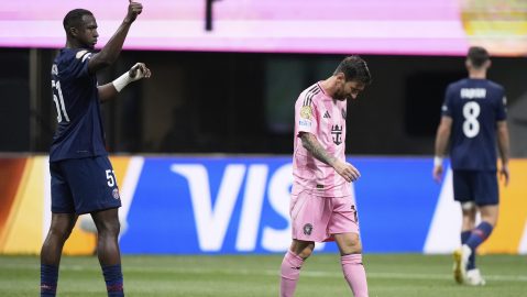 Paris Saint-Germain's Willian Pacho, left, signals as Inter Miami's Lionel Messi, center, walks away during the Club World Cup round of 16 soccer match between PSG and Inter Miami in Atlanta, Sunday, June 29, 2025. (AP Photo/Brynn Anderson)