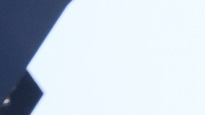 Alejandro Barranco checks his phone as he arrives to check on his father Narciso, who was detained by federal agents, outside the Metropolitan Detention Center on Monday, June 23, 2025, in Los Angeles. (AP Photo/Damian Dovarganes)