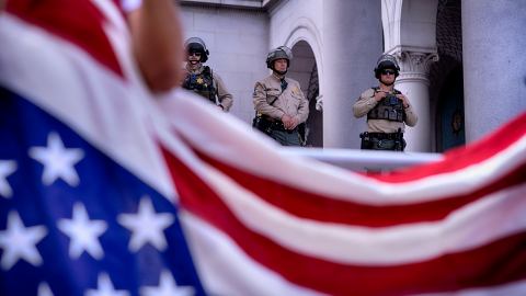 Los Angeles Sheriff's deputies stand guard on the steps of Los Angeles City Hall as protesters assemble during a "No Kings" protest in downtown Los Angeles on Saturday, June 14, 2025. (AP Photo/Richard Vogel)