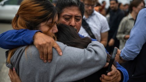 Jaslyn Hernandez, daughter of a car wash worker, embraces her sister Kimberly Hernandez, and their uncle Juan Medina during a press conference with families of detained car wash workers Wednesday, June 11, 2025, in Culver City, Calif. (AP Photo/Ethan Swope)