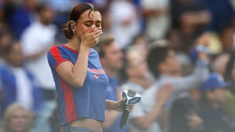 Music artist Nezza reacts after singing the national anthem prior to a baseball game between the Los Angeles Dodgers and the San Francisco Giants in Los Angeles, Saturday, June 14, 2025. (AP Photo/Jessie Alcheh)