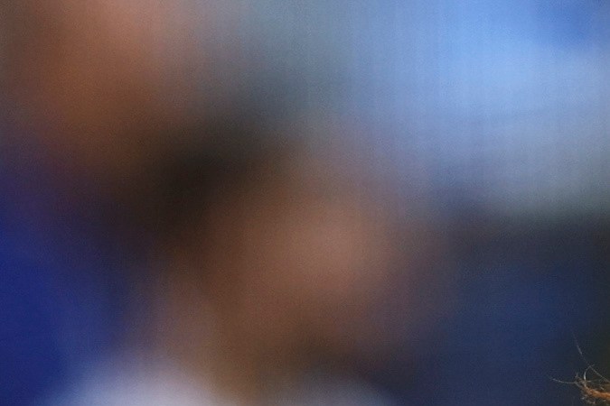 Music artist Nezza reacts after singing the national anthem