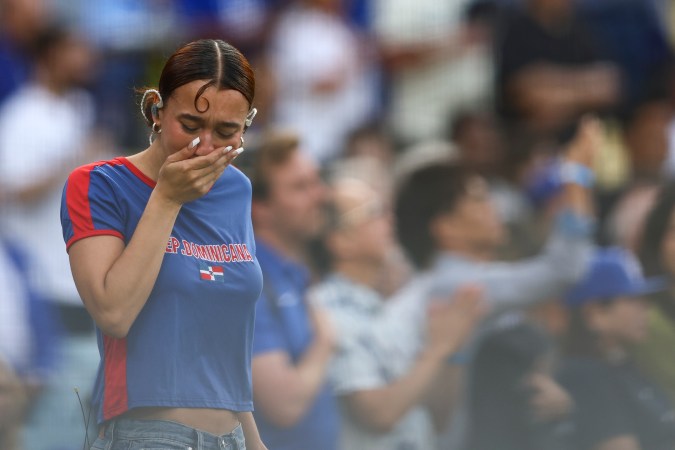 Music artist Nezza reacts after singing the national anthem