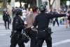 Los Angeles police detain a man during a protest Saturday, June 14, 2025, in Los Angeles. (AP Photo/Ethan Swope)