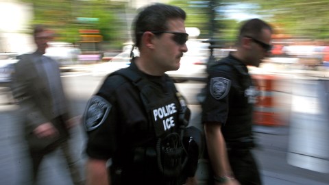 ***EDS NOTE: PHOTO TAKEN WITH SLOW SHUTTER SPEED*** Blurred by slow shutter speed, U.S Immigration and Customs Enforcement officers walk outside Manhattan Federal Court Tuesday, May 4, 2010 in New York. Times Square car bomb suspect Faisal Shahzad, who was arrested at New York's Kennedy Airport while trying to leave the country late Monday, is expected to appear in federal court Tuesday. (AP Photo/Jason DeCrow)