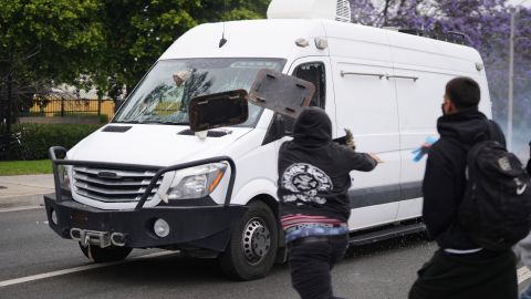 Protesters throw objects as law enforcement drive a van past during a protest in Paramount, Calif., Saturday, June 7, 2025, after federal immigration authorities conducted operations. (AP Photo/Eric Thayer)