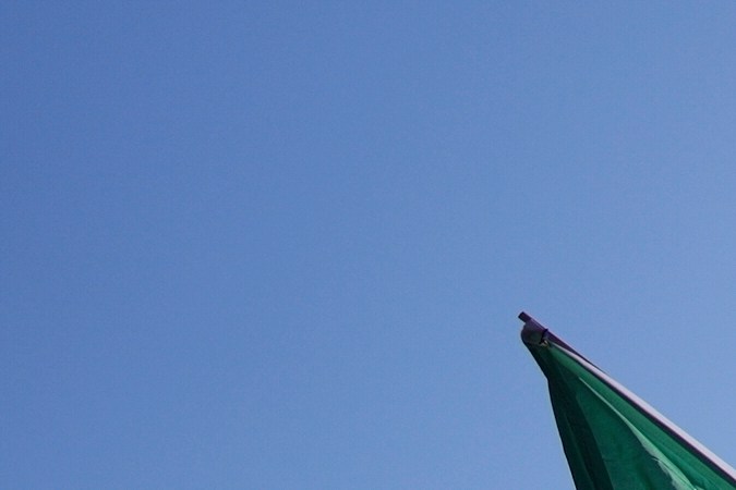 A protester leaps off a burning Waymo taxi near the Metropolitan Detention Center in downtown Los Angeles, Sunday, June 8, 2025, following last night's immigration raid protest. (AP Photo/Eric Thayer)