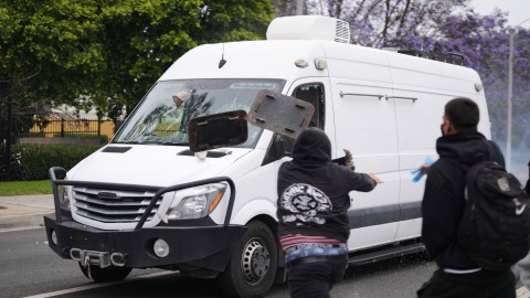Protesters throw objects as law enforcement drive a van past during a protest in Paramount, Calif., Saturday, June 7, 2025, after federal immigration authorities conducted operations. (AP Photo/Eric Thayer)