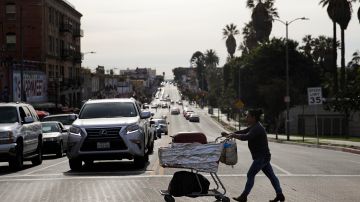 A food vendor pushes her cart Tuesday, Nov. 27, 2018, in Los Angeles. The Los Angeles City Council has voted overwhelmingly to make street vending legal. The 13-0 vote Wednesday came in a council chamber packed with more than 200 street vendors who broke into tears and shouts in Spanish of "we won, we won" after the vote was tabulated. (AP Photo/Jae C. Hong)