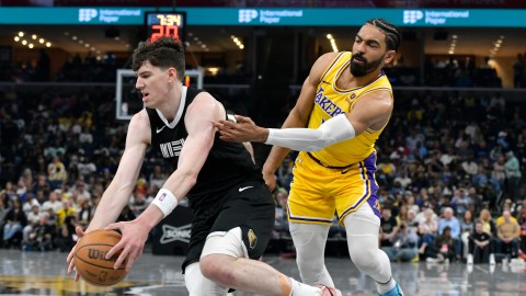 Memphis Grizzlies forward Jake LaRavia, left, drives next to Los Angeles Lakers guard Spencer Dinwiddie during the first half of an NBA basketball game Friday, April 12, 2024, in Memphis, Tenn. (AP Photo/Brandon Dill)