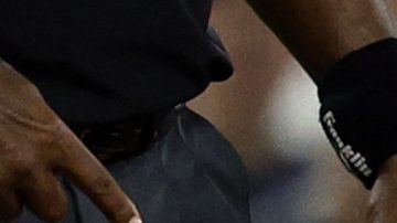 Los Angeles Dodgers' Max Muncy holds his knee after tagging out Chicago White Sox's Michael A. Taylor attempting to steal third base during the during the sixth inning Wednesday, July 2, 2025, in Los Angeles. (AP Photo/Kevork Djansezian)