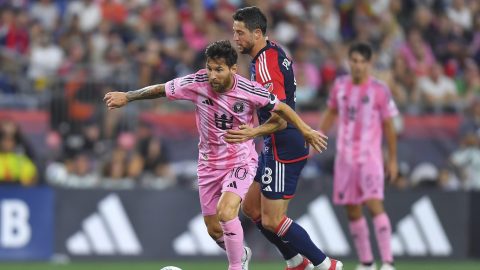Inter Miami forward Lionel Messi (10) and New England Revolution midfielder Matt Polster (8) vie for control of the ball during the second half of an MLS soccer match, Wednesday, July 9, 2025, in Foxborough, Mass. (AP Photo/Steven Senne)