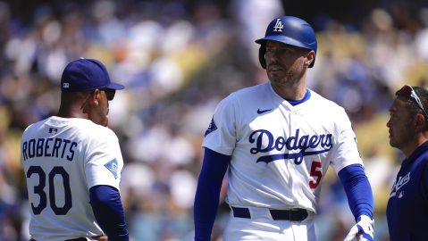 CORRECTS TO RIGHT Los Angeles Dodgers' Freddie Freeman, right, walks off the field as manager Dave Roberts stands by after being hit by a pitch during the sixth inning of a baseball game against the Milwaukee Brewers, Sunday, July 20, 2025, in Los Angeles. (AP Photo/Mark J. Terrill)