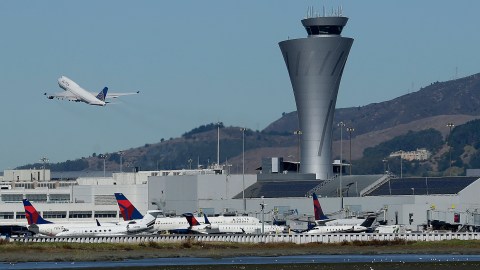 FILE - In this Oct. 24, 2017, file photo, the air traffic control tower is in sight as a plane takes off from San Francisco International Airport in San Francisco. Federal authorities have determined most of the close-calls reported since December 2016 at the busy San Francisco International Airport were caused by pilots. The East Bay Times reports Wednesday, May 2, 2018, the Federal Aviation Administration found that in three instances planes lined up for wrong runways and taxiways due to pilot error. A fourth plane was mistakenly cleared to land in the wrong runway by a tower controller.(AP Photo/Jeff Chiu, File)'