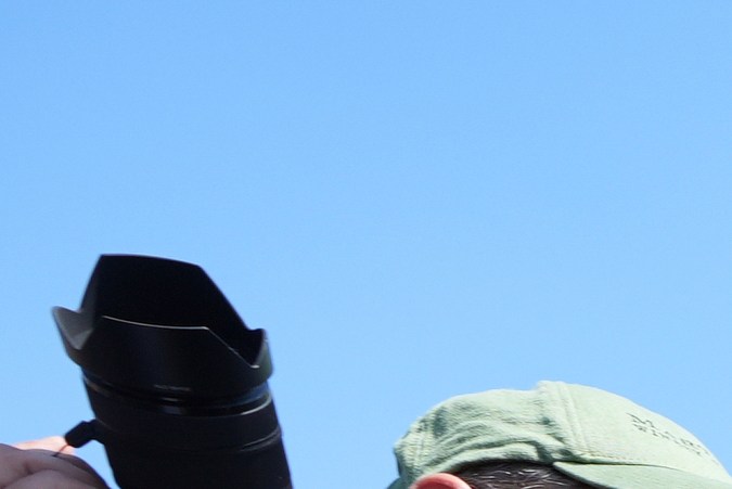 Los Angeles Mayor Karen Bass talks on her mobile phone next to a border patrol federal agent at MacArthur Park Monday, July 7, 2025, in Los Angeles. (AP Photo/Damian Dovarganes)