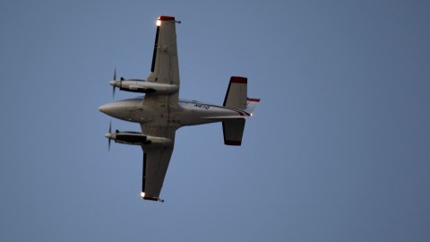 A Beechcraft airplane sprays the insecticide DUET over Dallas County to curb the spread of West Nile virus Sunday, Aug. 19, 2012, in Addison, Texas. Storms interrupted aerial spraying on Thursday and Friday nights but county official said they were able to spray about 88,000 acres with pesticide that targets mosquitoes on Friday night. The remaining 222,000 acres were expected to be sprayed Sunday night. (AP Photo/LM Otero)