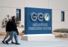 This Saturday, April 20, 2019 photo a couple walk out of the U.S. Immigration and Enforcement Processing Center operated by GEO Group, Inc. (GEO) a Florida-based company specializing in privatized corrections in Adelanto, Calif. (AP Photo/Richard Vogel)