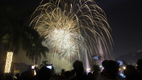 Filipinos watch a fireworks display as they welcome the New Year at Manila's Rizal Park, Philippines on Sunday Jan. 1, 2012. More than 200 people have been injured by illegal firecrackers and celebratory gunfire in the Philippines despite a government scare campaign against reckless New Year revelries, officials recently said. (AP Photo/Aaron Favila)