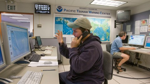 Victor Sardina, left, fields phone calls at the Richard H. Hagemeyer Pacific Tsunami Warning Center located in Ewa Beach on the island of Oahu Wednesday Oct. 7, 2009. Three powerful earthquakes struck the South Pacific near the Vanuatu archipelago Thursday, generating a small tsunami just over a week after another, massive wave killed 178 people in the Samoas and Tonga. There were no immediate reports of damage, and all tsunami warnings and watches for the Pacific were canceled two hours after they were first issued. (AP Photo/Eugene Tanner)
