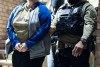 U.S. Immigration and Customs Enforcement officers detain a person, left, Monday, Jan. 27, 2025, in Silver Spring, Md. (AP Photo/Alex Brandon)