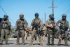 Federal immigration agents block the road during a raid in the agriculture area of Camarillo, Calif., Thursday, July 10, 2025. (AP Photo/Michael Owen Baker)