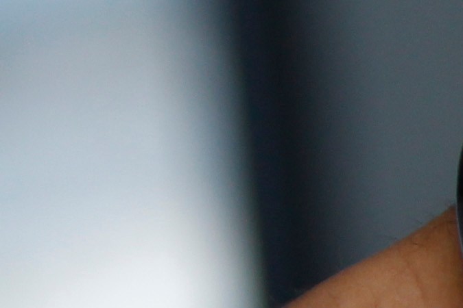 A handcuffed suspect waits inside a police bus during an operation against alleged drug traffickers at the Complexo do Alemao slum in Rio de Janeiro, Brazil, Saturday, Nov. 27, 2010. Soldiers and police crouching behind armored vehicles trained their rifles on dozens of entrances to a sprawling slum Saturday, preparing to invade and try to push drug gangs out an area long considered the most dangerous in Rio de Janeiro, a city set to host the 2016 Olympics. (AP Photo/Felipe Dana)