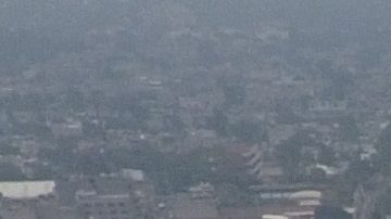 Pollution blankets the sky over the iconic Estadio Azteca and the rest of Mexico City, Thursday, May 16, 2019. A semifinal match between America and Leon that had already been postponed due to air quality will be played out of the city in Queretaro on Thursday. (AP Photo/Rebecca Blackwell)