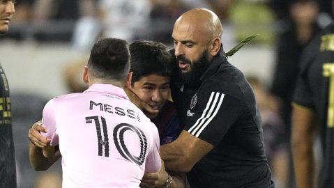 A young fan, center, is intercepted by security while trying to hug Inter Miami forward Lionel Messi during the second half of a Major League Soccer match against Los Angeles FC Sunday, Sept. 3, 2023, in Los Angeles. (AP Photo/Mark J. Terrill)