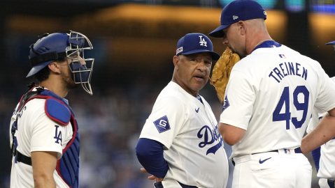 Los Angeles Dodgers manager Dave Roberts, center, talks with relief pitcher Blake Treinen, right, and catcher Austin Barnes during the sixth inning of a baseball game against the Kansas City Royals Saturday, June 15, 2024, in Los Angeles. (AP Photo/Mark J. Terrill)