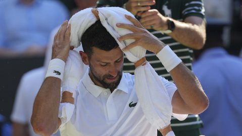 Serbia's Novak Djokovic tries to keep cool during a change of ends break against Italy's Jannik Sinner in a men's singles semifinal at the Wimbledon Tennis Championships in London, Friday, July 11, 2025. (AP Photo/Kin Cheung)