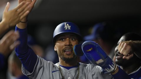 Los Angeles Dodgers' Mookie Betts celebrates after scoring on a single hit by Freddie Freeman in the seventh inning of a baseball game against the Cincinnati Reds, Tuesday, July 29, 2025, in Cincinnati. (AP Photo/Carolyn Kaster)