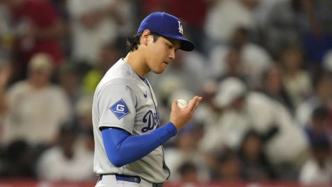 Los Angeles Dodgers starting pitcher Shohei Ohtani looks at his fingers during the fifth inning of a baseball game against the Los Angeles Angels, Wednesday, Aug. 13, 2025, in Anaheim, Calif. (AP Photo/Mark J. Terrill)