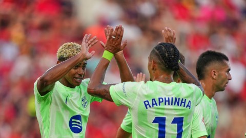 Barcelona's Lamine Yamal left, and Raphinha celebrate after a goalduring the La Liga soccer match between Mallorca and Barcelona in Mallorca, Spain, Saturday, Aug. 16, 2025. (AP Photo/Joan Mateu Parra)