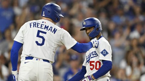 Los Angeles Dodgers Mookie Betts (50) is congratulated by Dodgers' Freddie Freeman after hitting a solo home run during the sixth inning of a baseball game Monday, Aug. 25, 2025, in Los Angeles. (AP Photo/Jayne Kamin-Oncea)