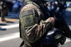 An ICE Special Response Team member stands guard outside the Metropolitan Detention Center, while protesters gathered outside to denounce ICE operations, Tuesday, June 10, 2025, in downtown Los Angeles. (AP Photo/Eric Thayer)