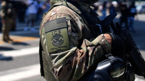 An ICE Special Response Team member stands guard outside the Metropolitan Detention Center, while protesters gathered outside to denounce ICE operations, Tuesday, June 10, 2025, in downtown Los Angeles. (AP Photo/Eric Thayer)