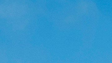 Federal immigration agents toss tear gas at protesters during a raid in the agriculture area of Camarillo, Calif., Thursday, July 10, 2025. (AP Photo/Michael Owen Baker)