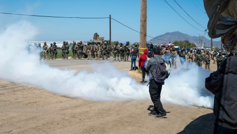 Federal immigration agents toss tear gas at protesters during a raid in the agriculture area of Camarillo, Calif., Thursday, July 10, 2025. (AP Photo/Michael Owen Baker)