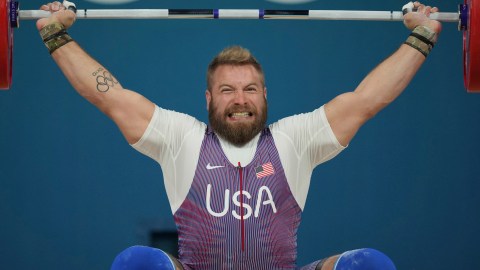 Wes Kitts of the United States competes during the men's 102kg weightlifting event, at the 2024 Summer Olympics, Saturday, Aug. 10, 2024, in Paris, France. (AP Photo/Kin Cheung)