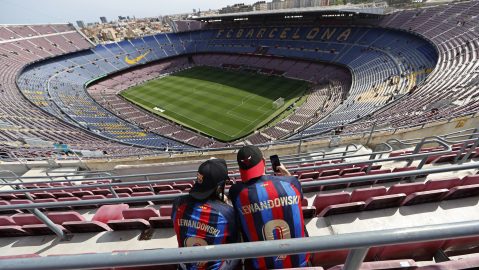 FILE - Two Barcelona fans wait for the start of a Spanish La Liga soccer match between Barcelona and Mallorca at the Camp Nou stadium in Barcelona, Spain, Sunday, May 28, 2023. (AP Photo/Joan Monfort, File)