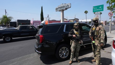 Immigration agents conduct an operation at a car wash on Friday, Aug. 15, 2025, in Montebello, Calif. (AP Photo/Gregory Bull)
